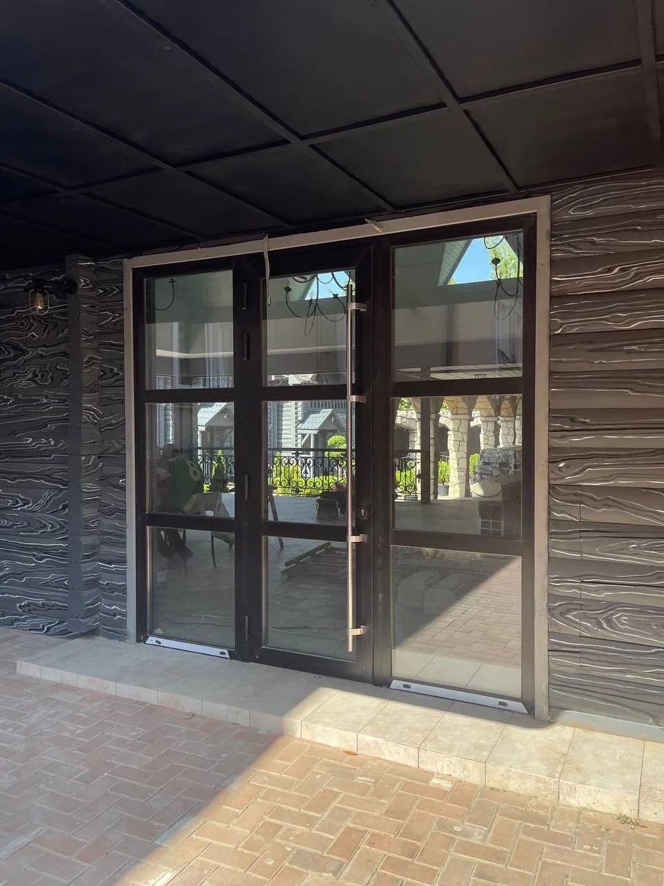 Aluminium-framed glazed entrance doors of a restaurant