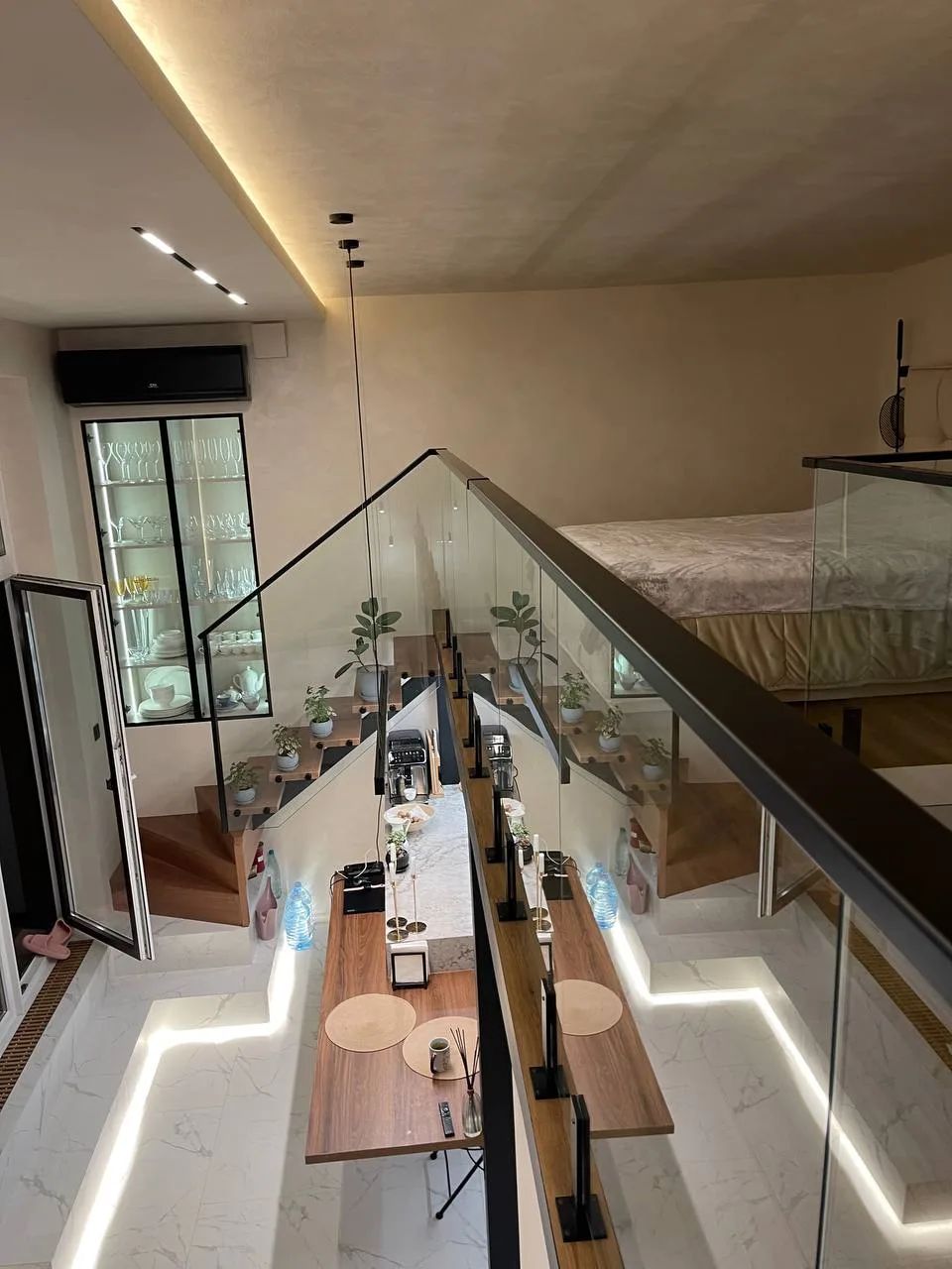 Glass railing along the upper level of a two-level apartment