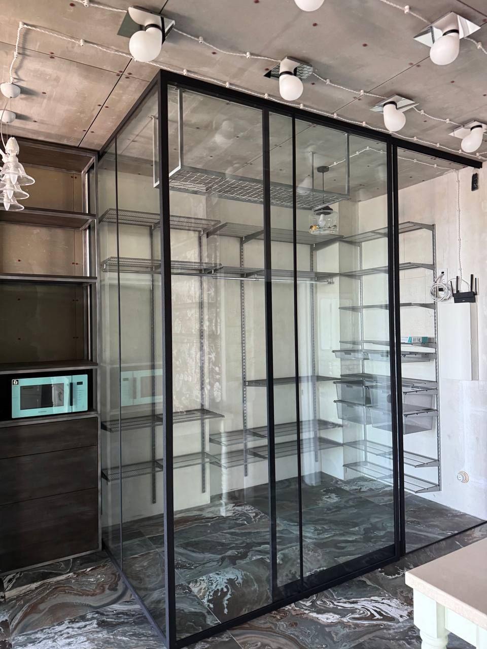 Corner Loft-style glass partition around a wardrobe area